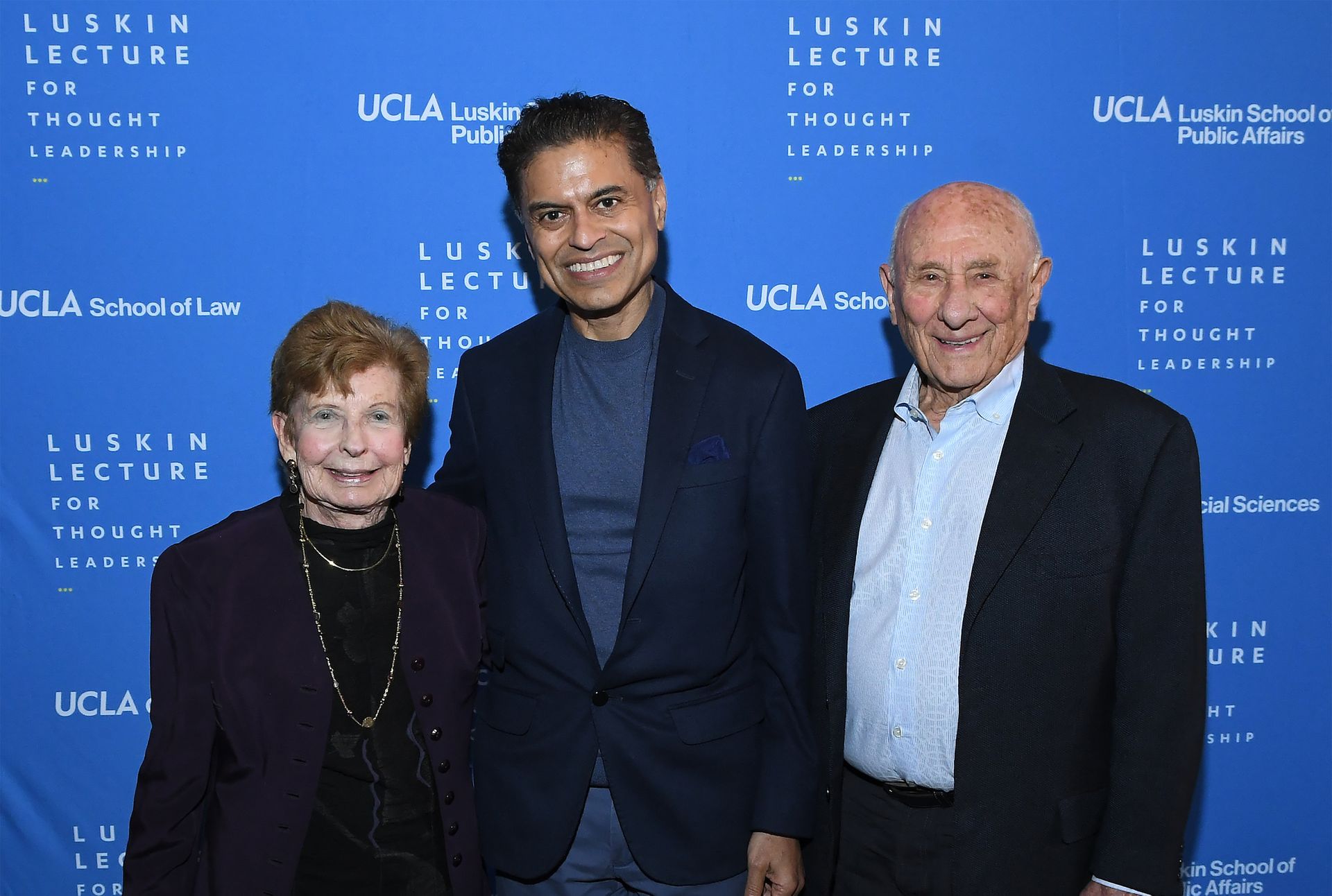Standing together, from left: Renee Luskin, Fareed Zakaria and Meyer Luskin