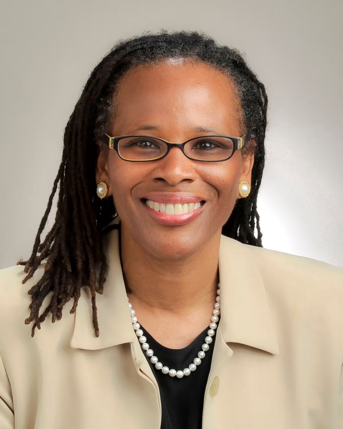 Donna Washington — vertical head-and shoulders photo in tan jacket