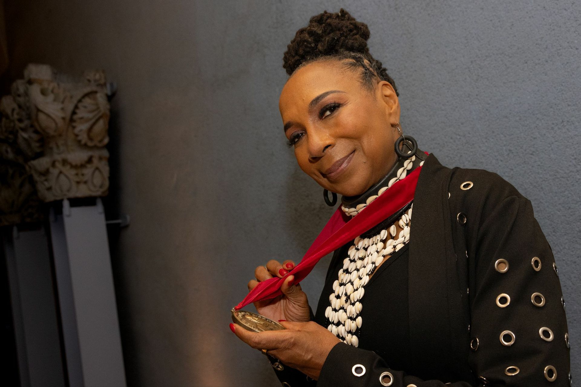 Kimberlé Crenshaw holding a medal