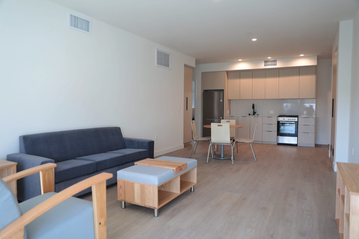 Interior of unit at Canfield Apartments showing living area and kitchen area