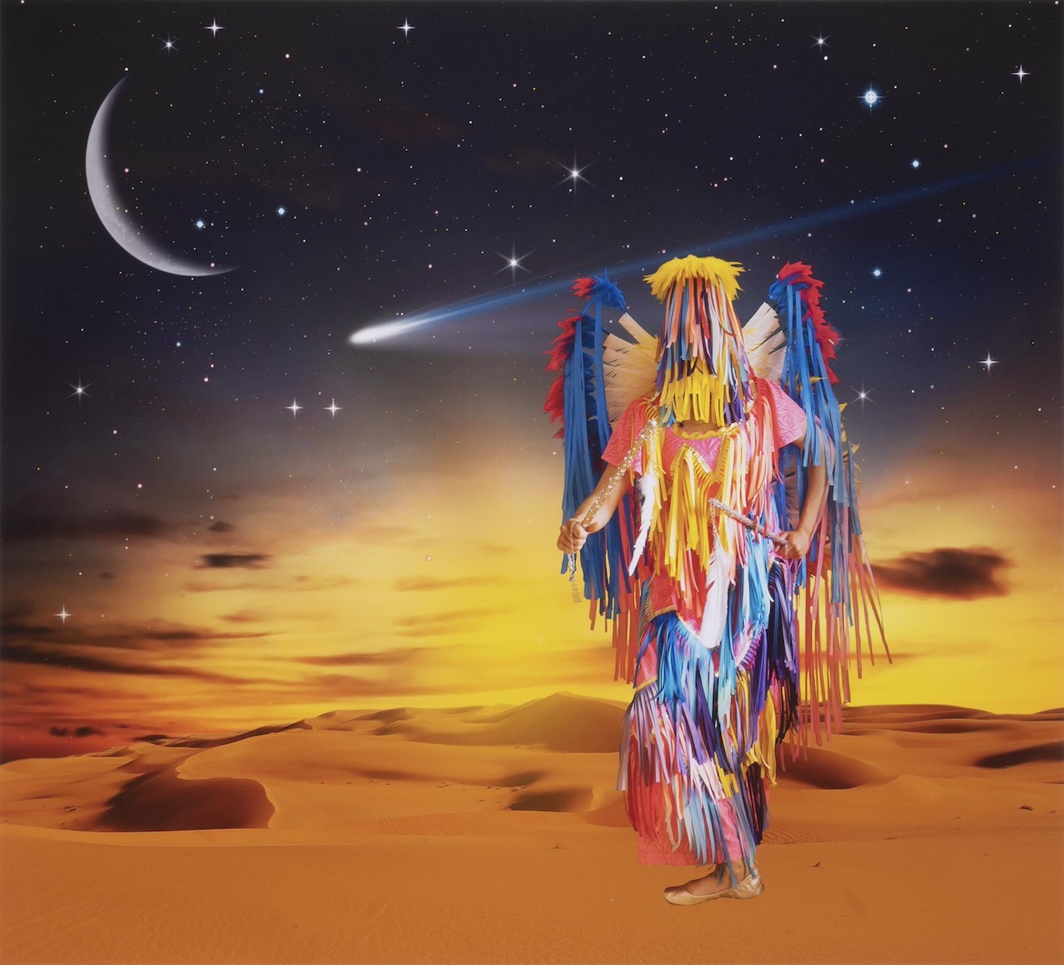 Artwork by Wendy Red Star — a figure in futuristic powwow regalia standing on a distant planet.