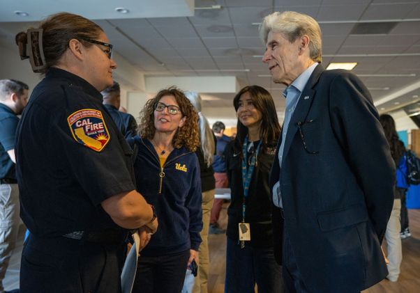 Chancellor Julio Frenk speaks with representative of CAL FIRE