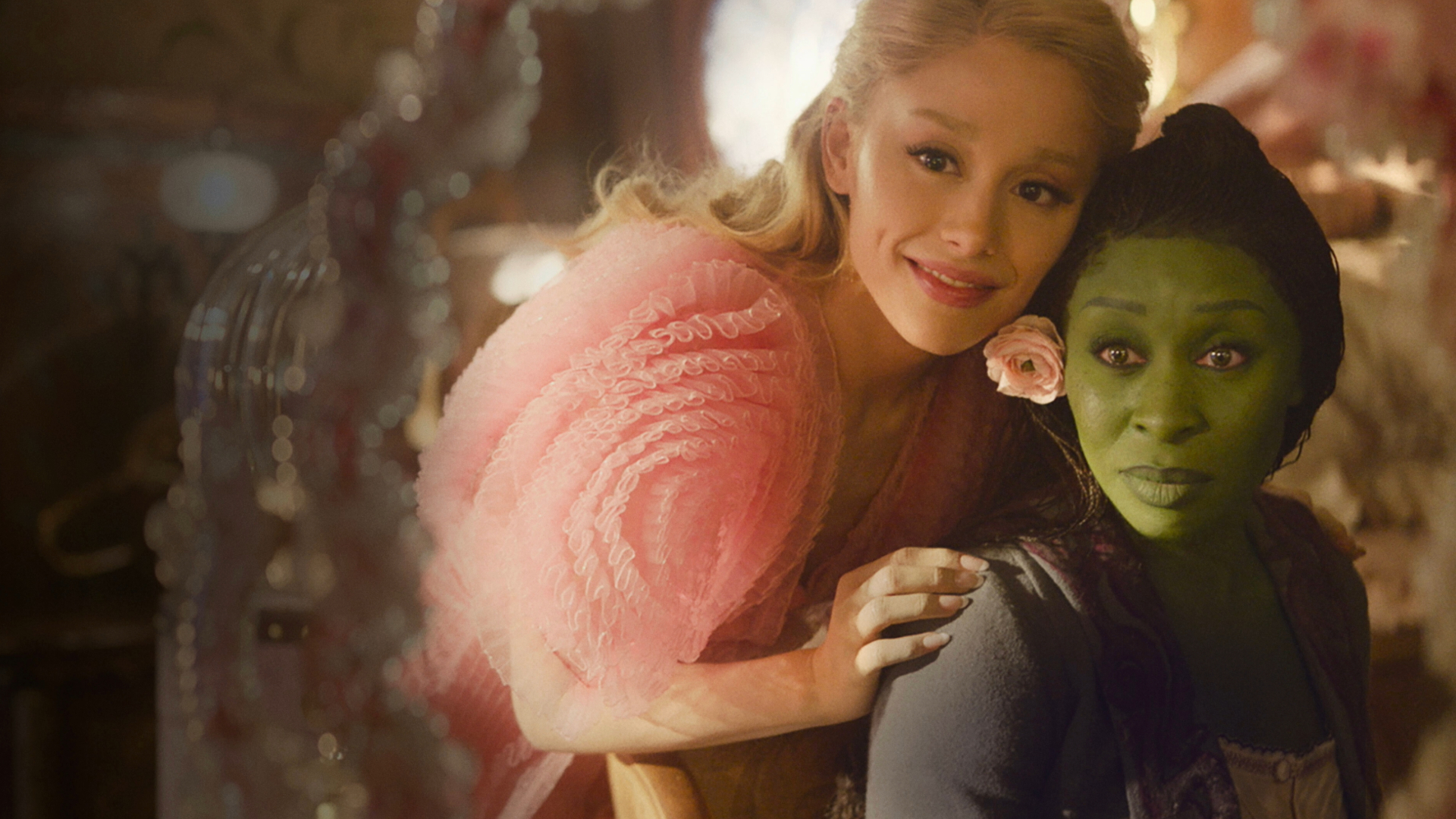 “Wicked” actors Ariana Grande and Cynthia Erivo look in a mirror in one of the film's scenes