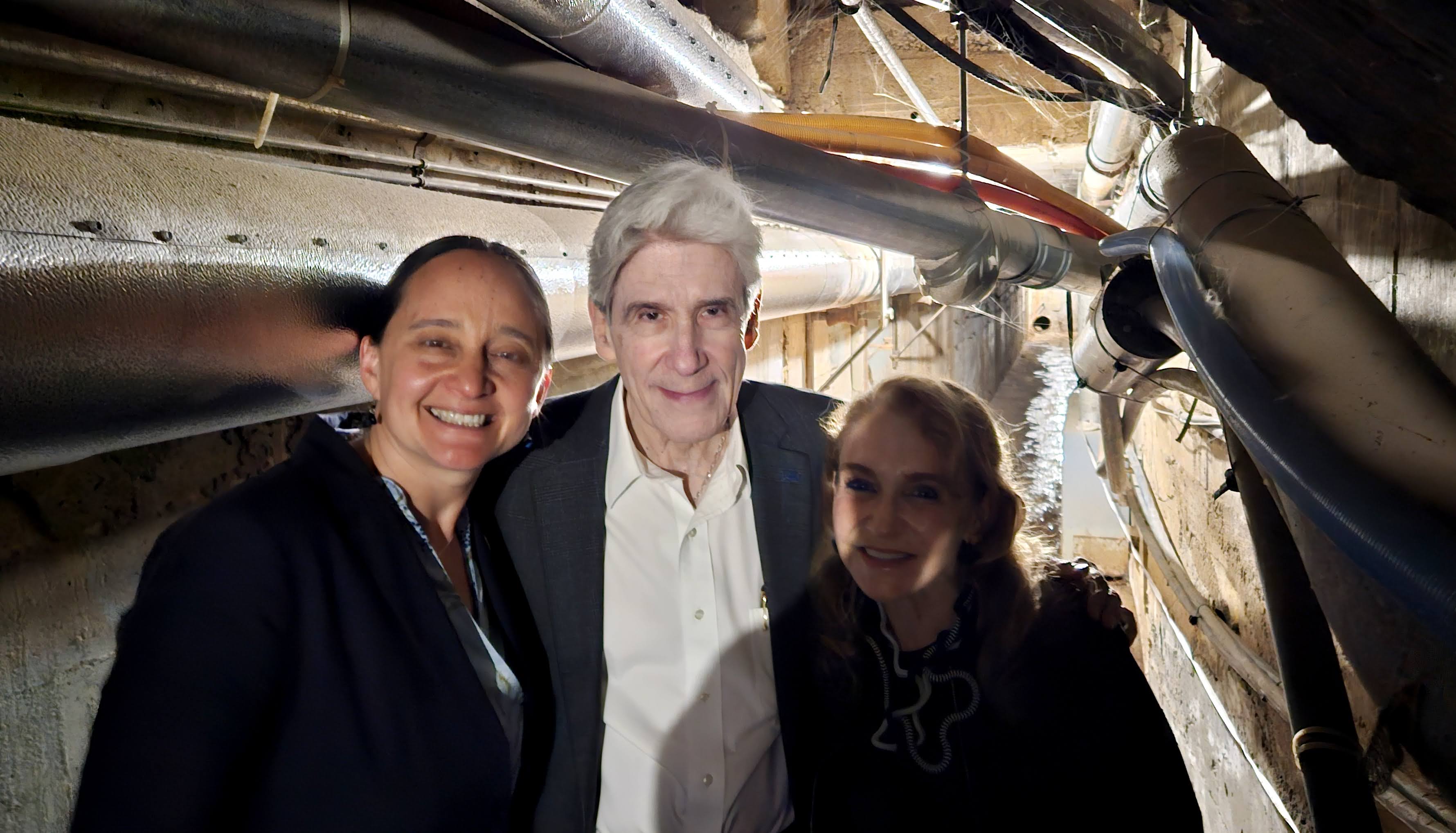 Nurit Katz, Julio Frenk and Felicia Knaul stand in tunnel with pipes on either side