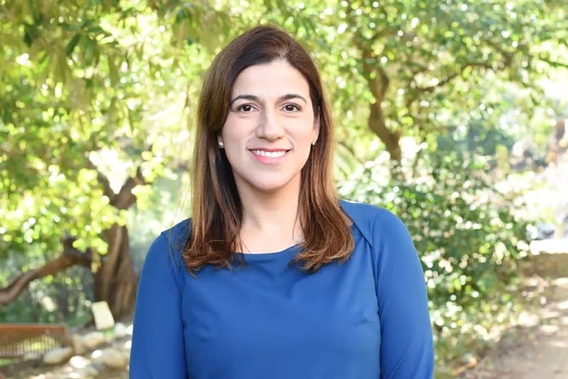 Paula Ortega-Verdugo, in blue top, with trees background