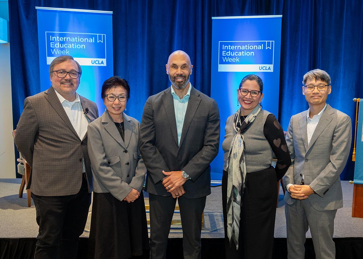 Five people pose for a group photo on stage at UCLA International Education Week. Left to right: Miguel García-Garibay, Cindy Fan, Darnell Hunt, Athena Jackson and David Kim.