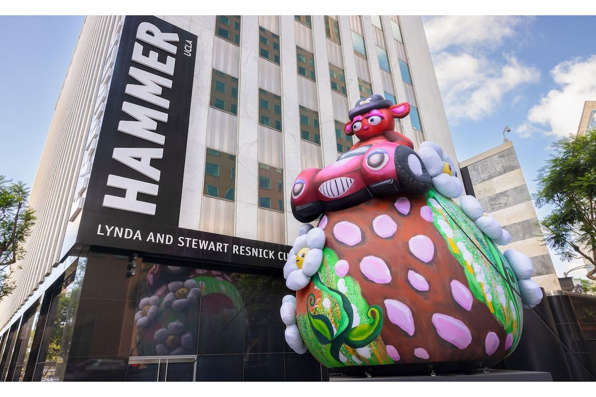 Buggy bear inflatable sculpture next to Hammer UCLA sign on building