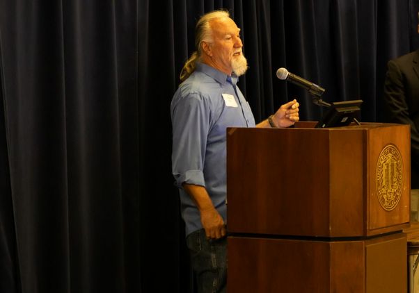 Daniel Martin speaks at a podium at the UCLA Veterans Day reception, where he was recognized as Veteran of the Year.