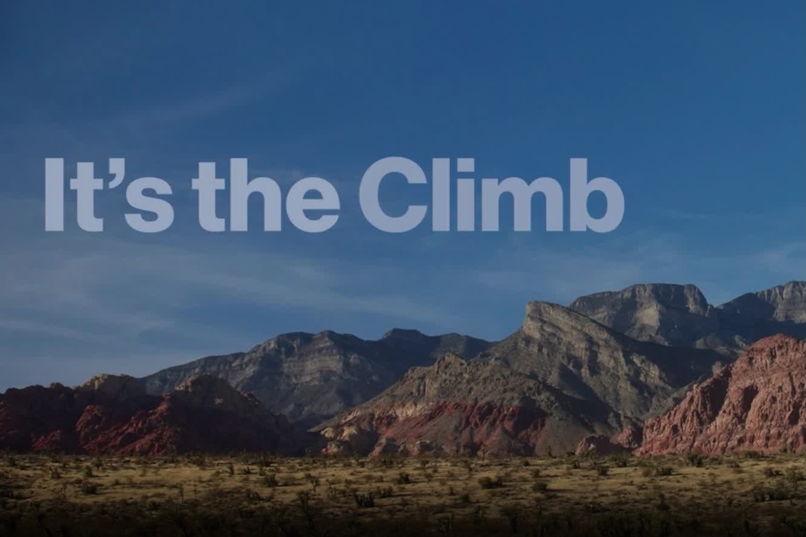 A scenic landscape of red rock formations under a blue sky, with text overlay reading 'It's the Climb,' representing the UCLA rock climbing team feature.