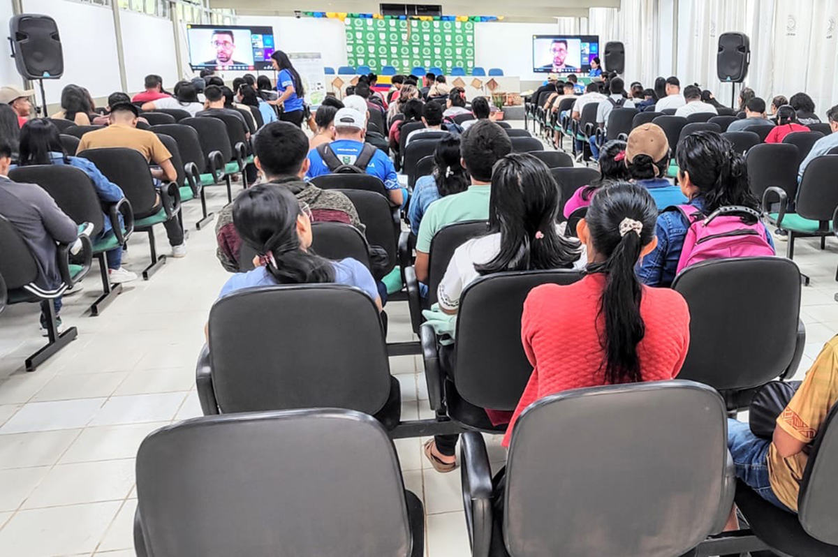View of students in classroom from behind with two display monitors up front