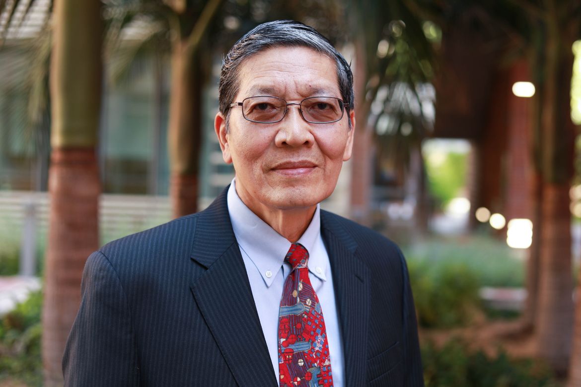 Wentai Liu profile picture standing in front of palm trees 