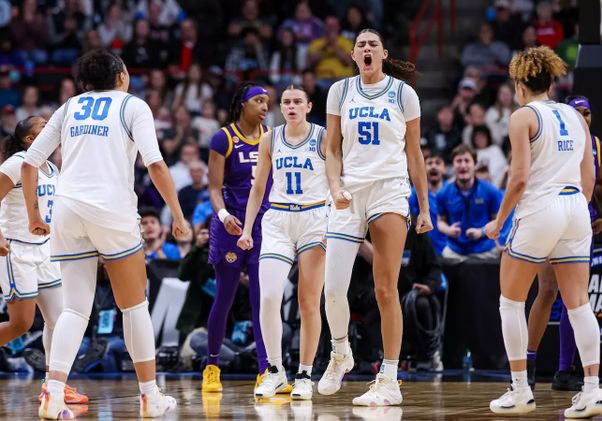 UCLA women's basketball players celebrate on the court during their March 30 win over the LSU Tigers.