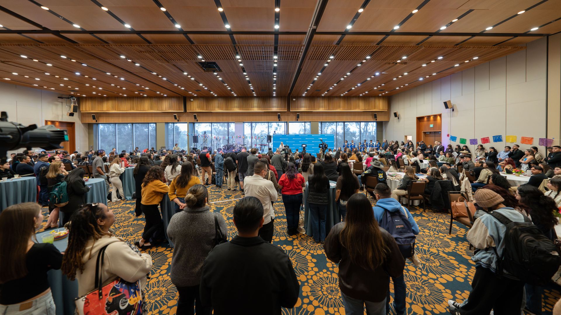 Attendees watching programming for the opening of the Latinx Success Center