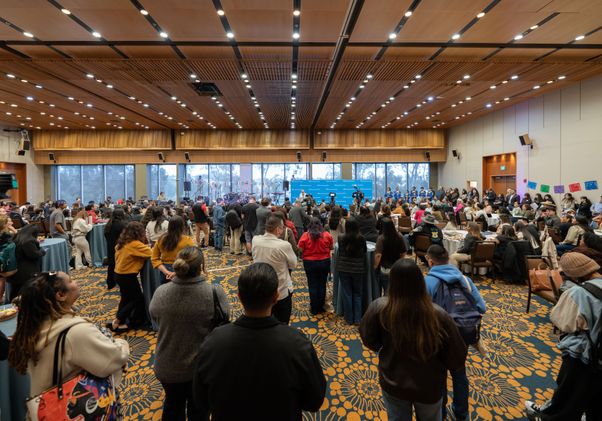 Attendees watching programming for the opening of the Latinx Success Center