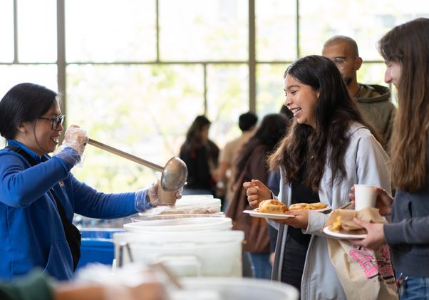 Students enjoy food at the opening of the Latinx Success Center