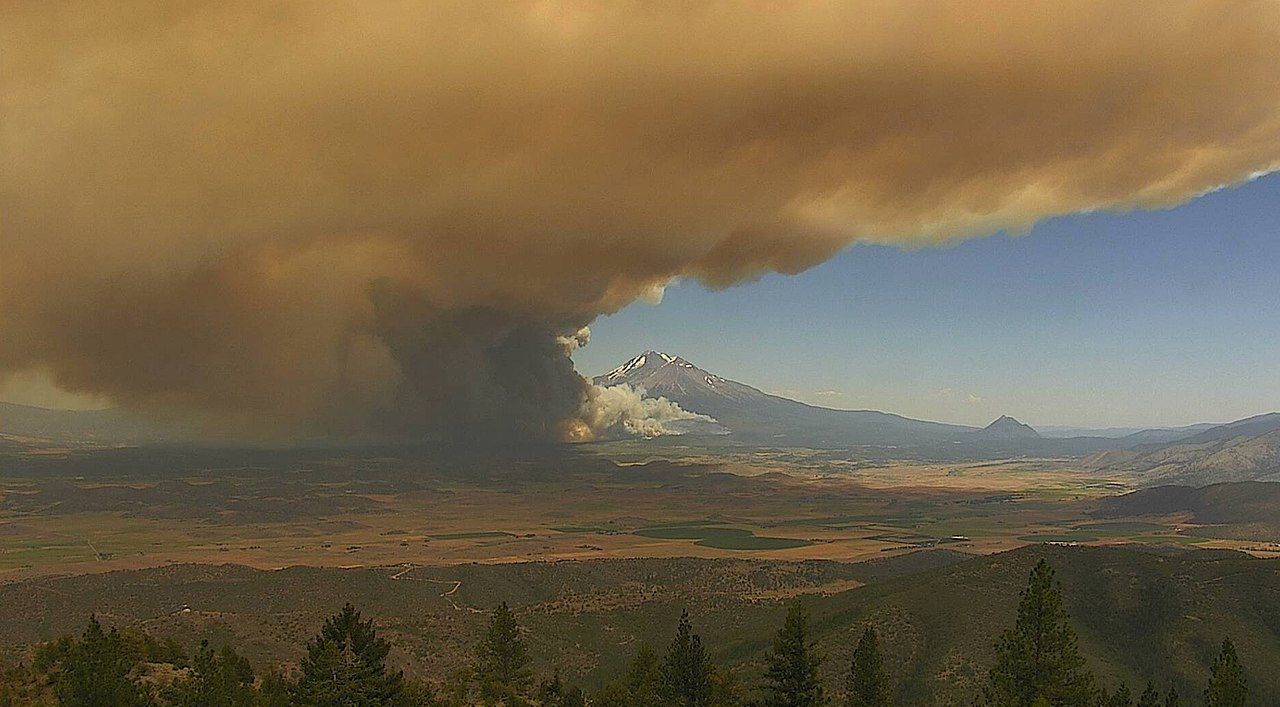2021 Tennant Fire smoke rises in front of a mountain in Yreka, Calif.