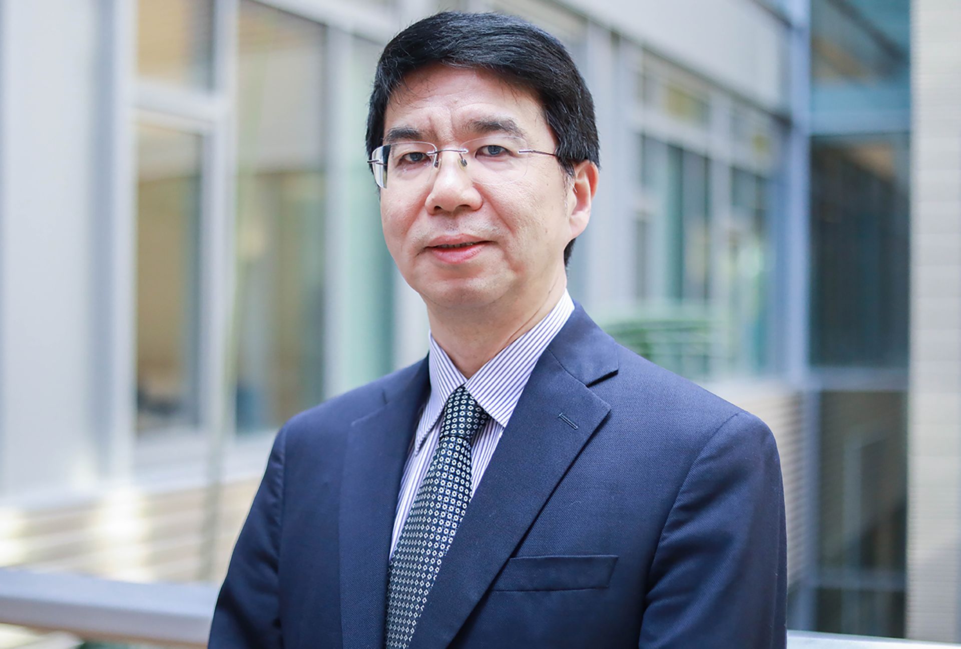 Head-and-shoulders photo of Jason Cong in blue suit and tie