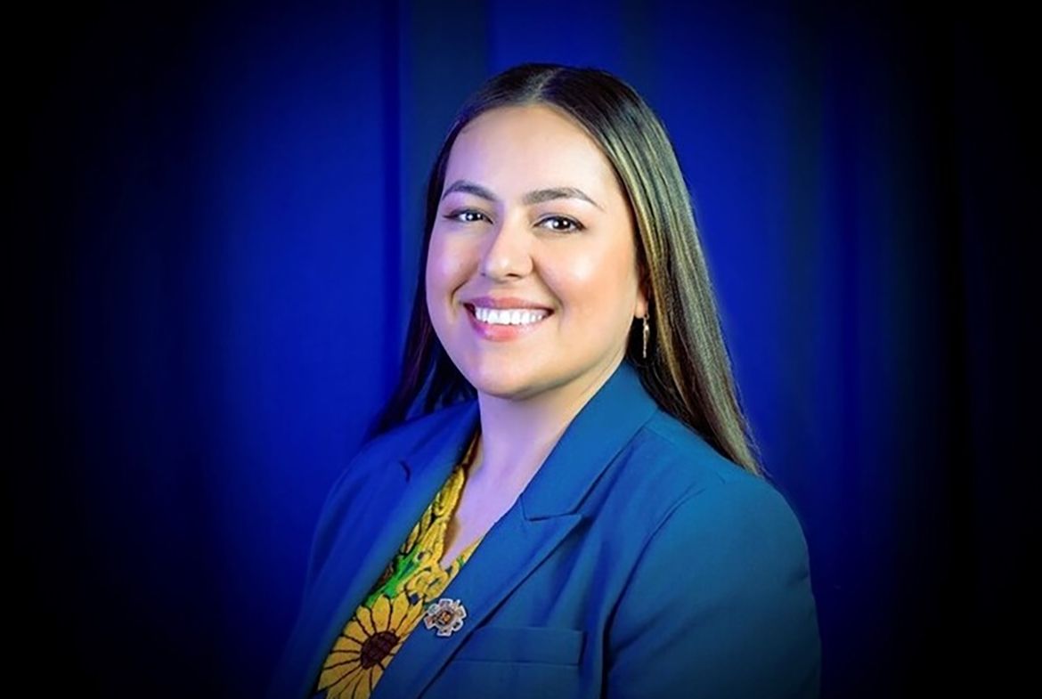 Head-and-shoulders photo of Arlene Cano Matute in blue jacket and floral-patterned top