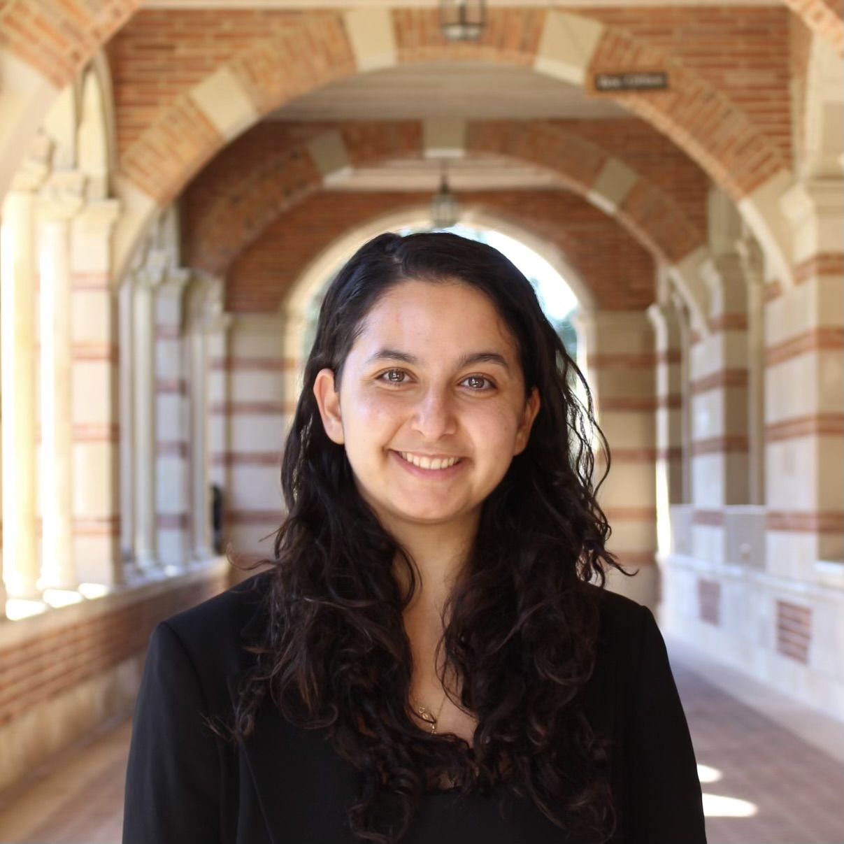 Portrait of UCLA student Nour Rayess in Royce Hall outside hallway. 