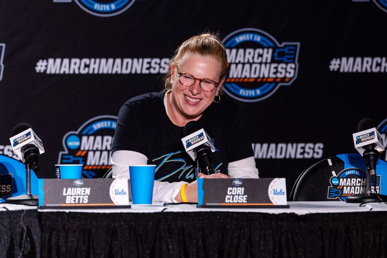 UCLA women’s head coach Cori Close at table at press conference for the the 2025 NCAA tournament.