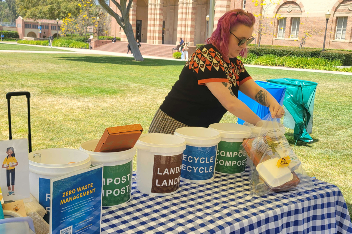 UCLA Zero Waste manager Jade Goegebuer gathers used food containers for a waste sorting game.
