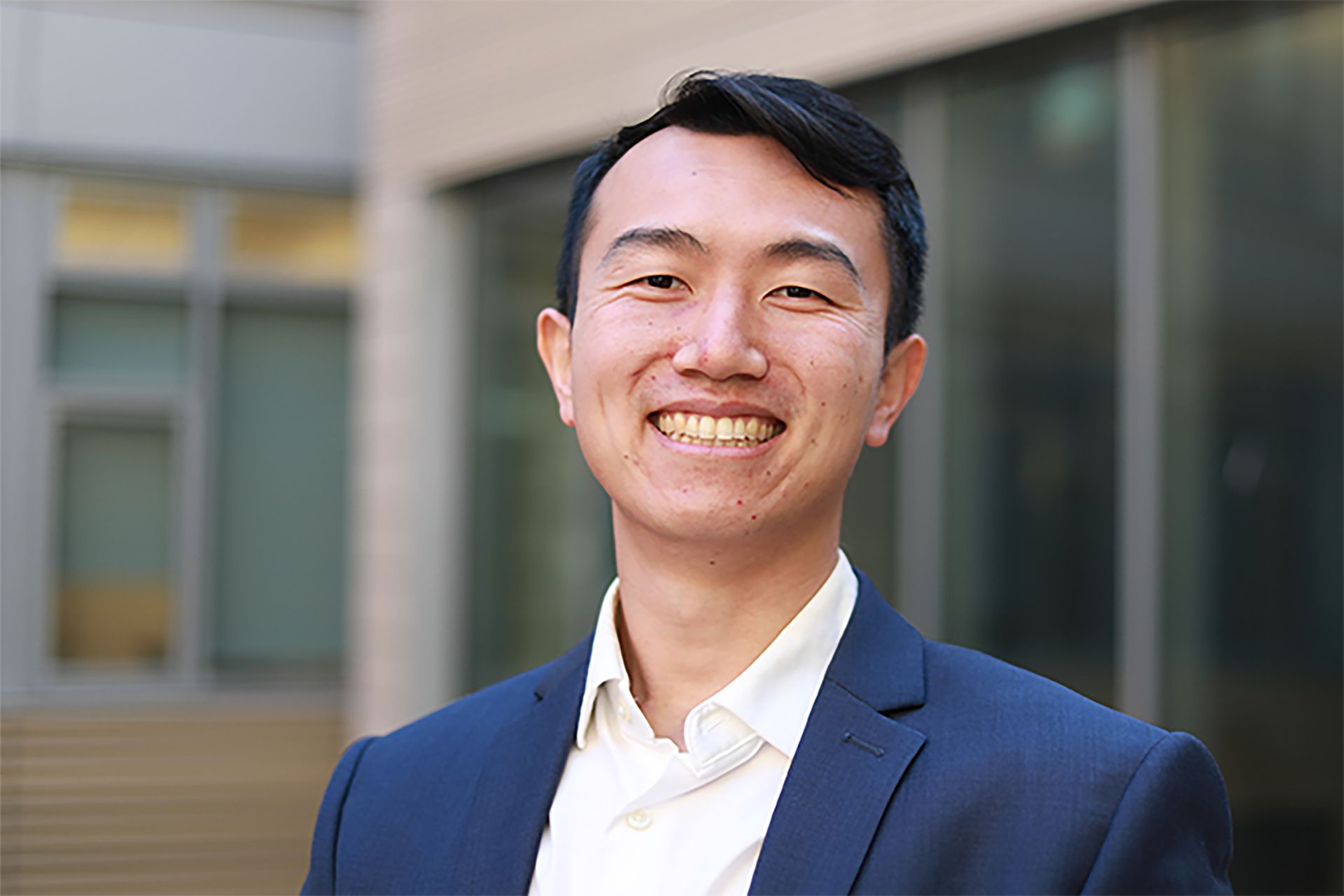 Head-and-shoulders photo of Yuzhang Li in blue jacket and white shirt