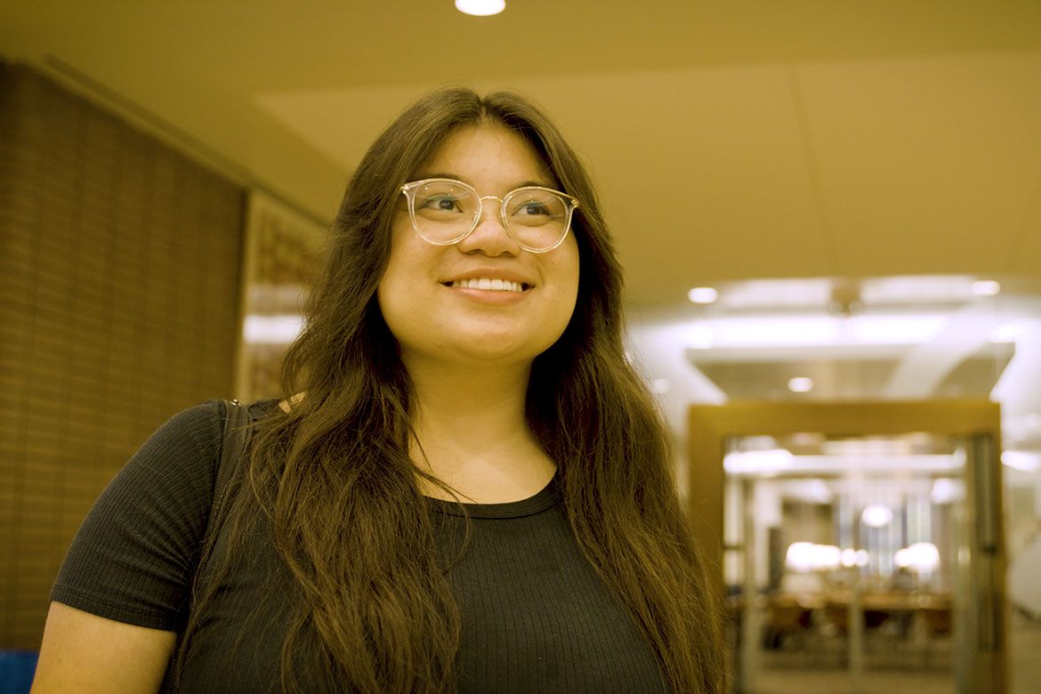 Head-and-shoulders photo of Evelyn Giron in black top and glasses