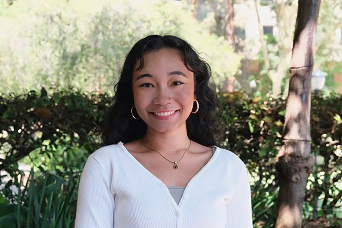 Head-and-shoulders photo of Shanti Fukasaku, in white top and hoop earrings