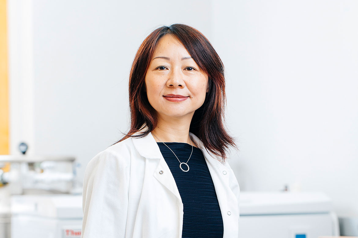 Head-and-shoulders photo of Lili Yang in dark blue top and white coat