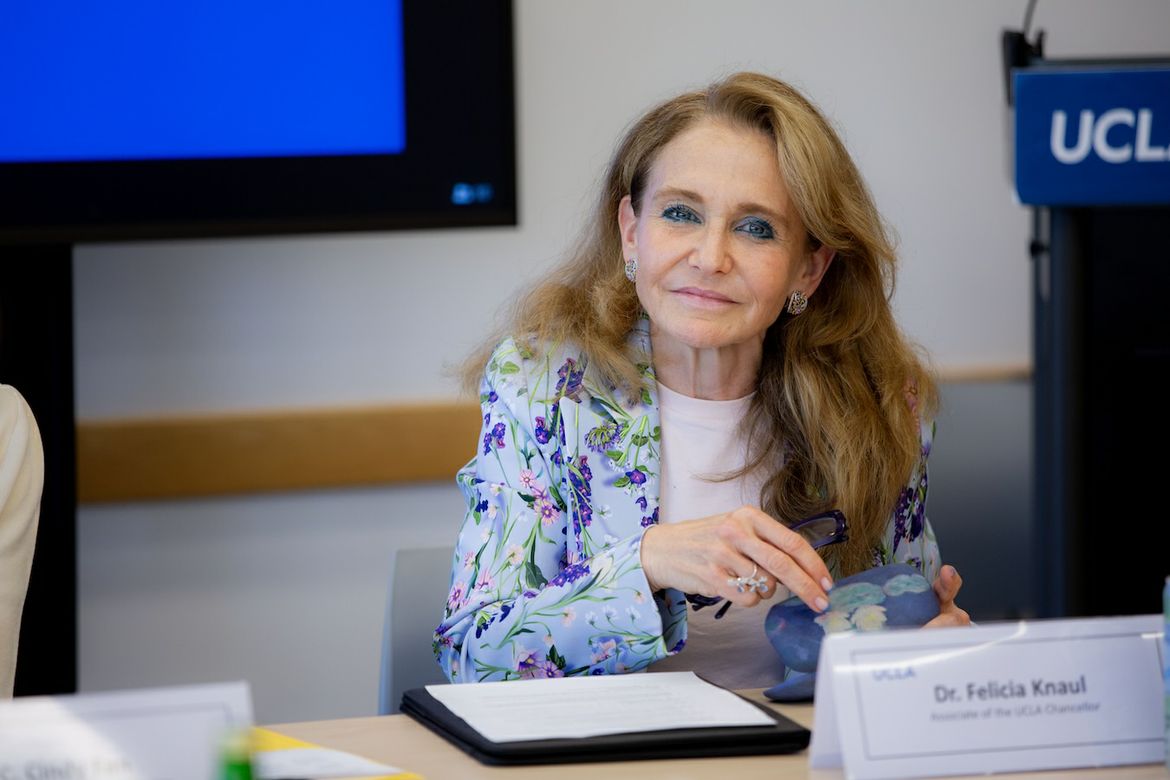 Felicia Marie Knaul seated at table and UCLA International Institute event