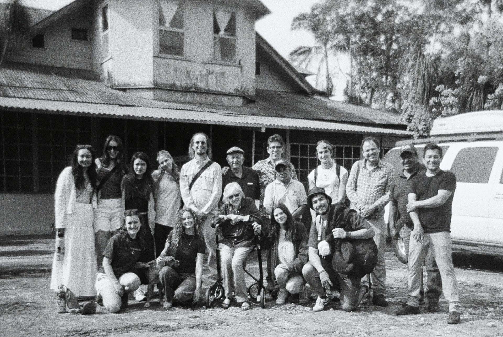 Black-and-white group photo of approximately 15 members of the UCLA Guatemala Practicum team, including students and faculty advisors, standing and kneeling in front of a building.