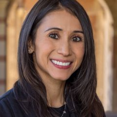 Adriana Galván in Royce Hall's stone corridor. 