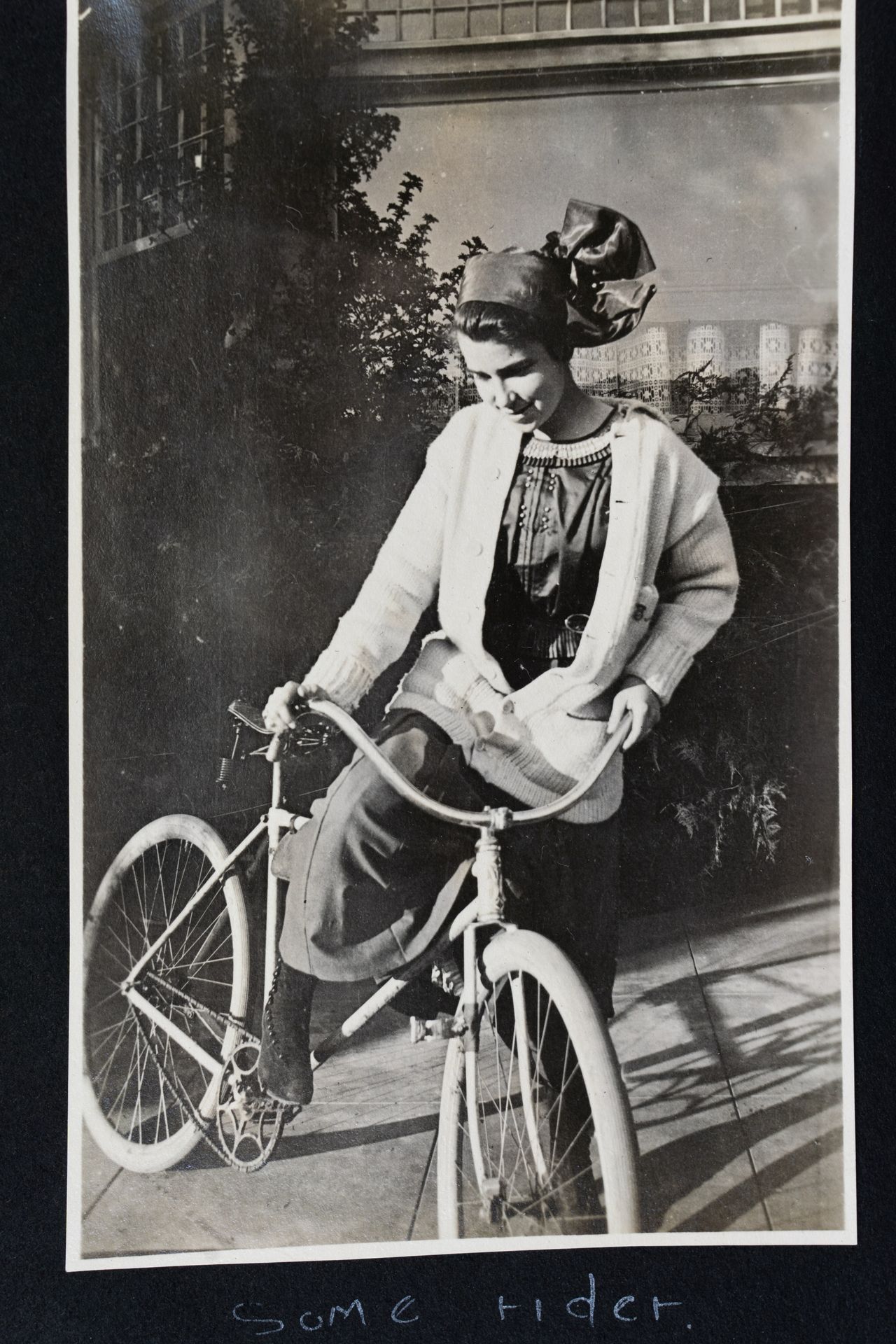 A scan of a photo of young Dorothy Arzner with bicycle 