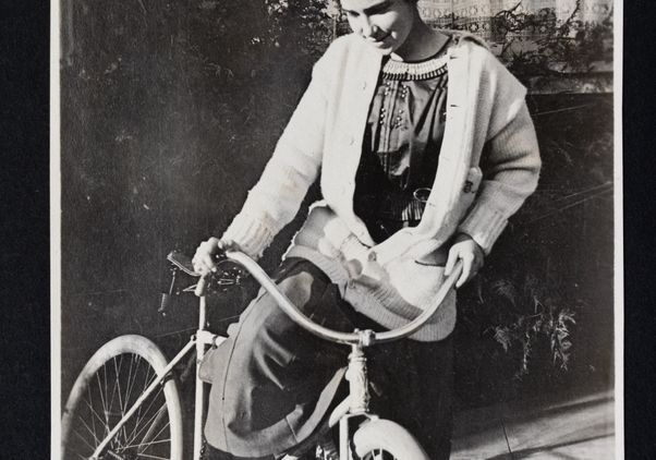 A scan of a photo of young Dorothy Arzner with bicycle 