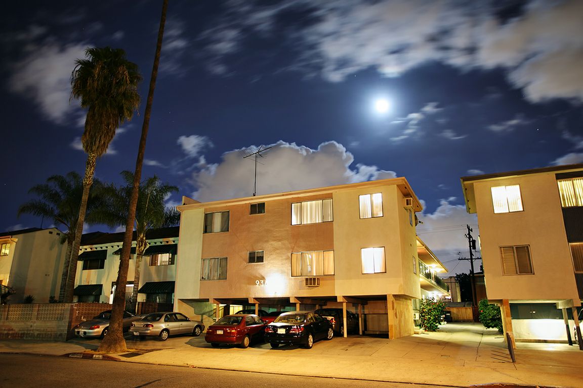 An apartment building with cars parked out front
