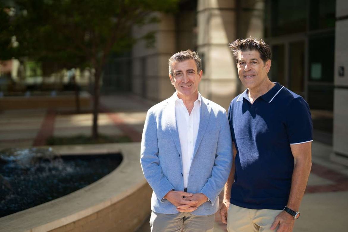 From left: Dr. Drew Moghanaki, chief of thoracic oncology at UCLA, stands with Paul Hendrix next to a water fountain