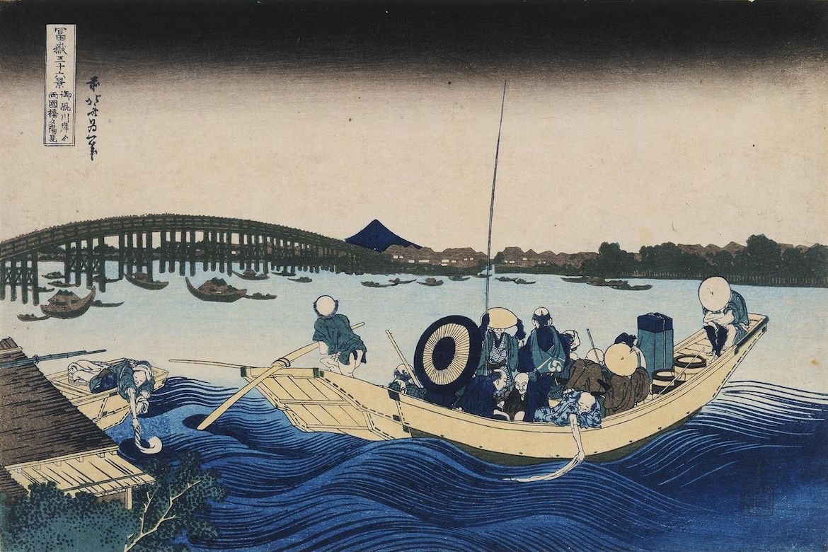 Japanese print in blue, brown and gray of men in a boat looking at a bridge from an embankment