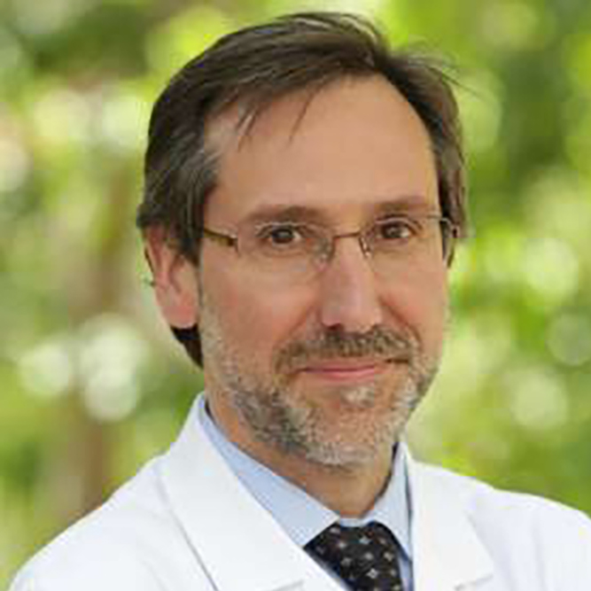 Close-up shot of Antoni Ribas in white coat and glasses