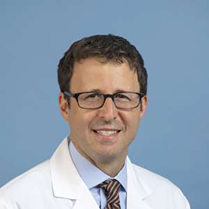 Richard Finn in white coat, blue shirt and glasses