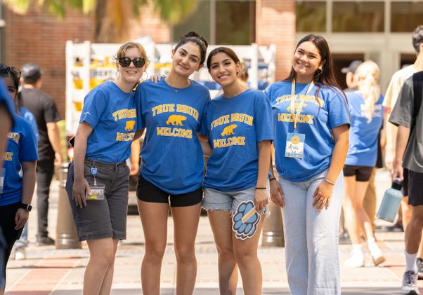 Move-in: Four student volunteers in "True Bruin Welcome" T-shirts