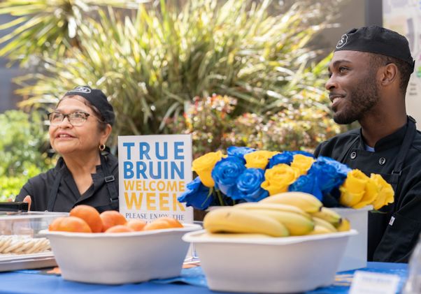 Move-in: Two UCLA Dining staff at table with food