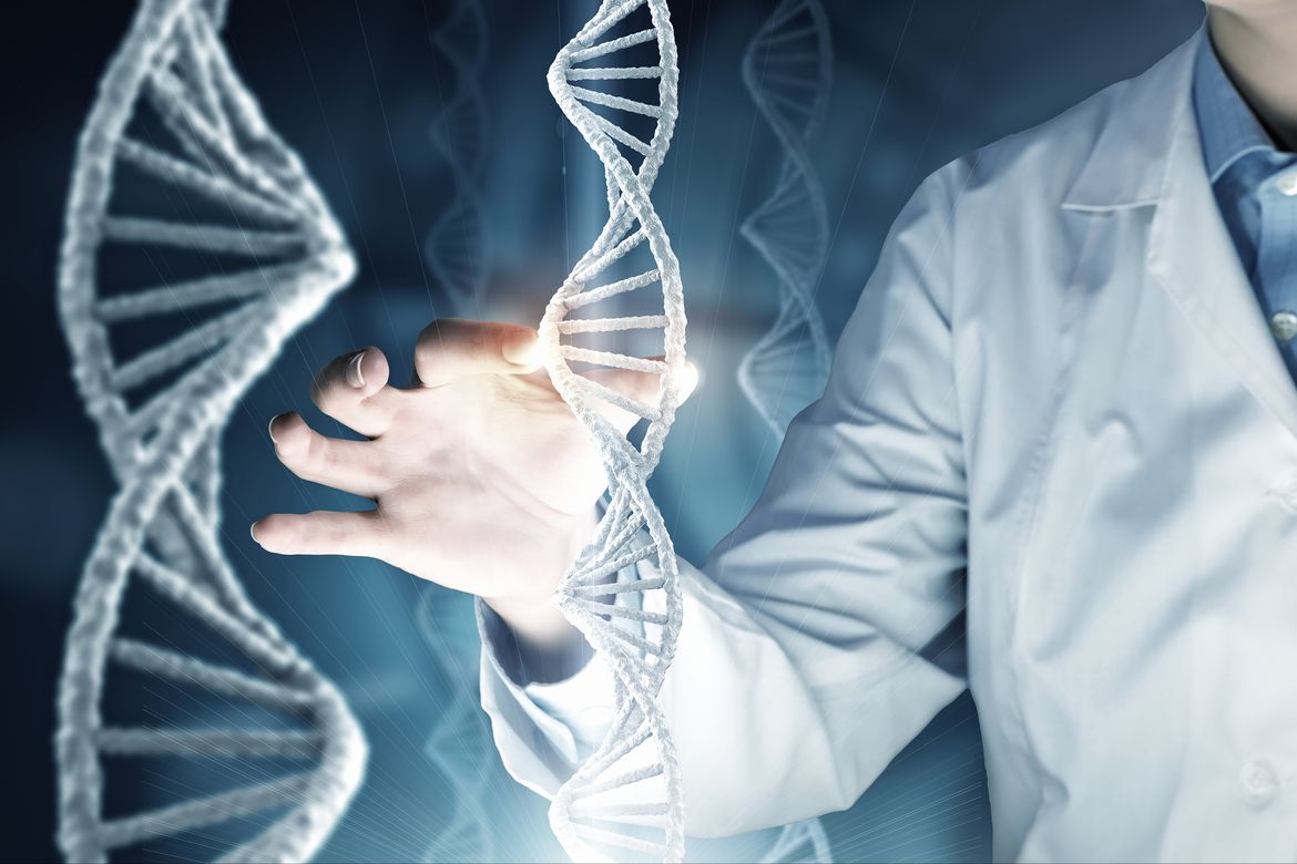Image of person in lab coat holding a large white DNA strand