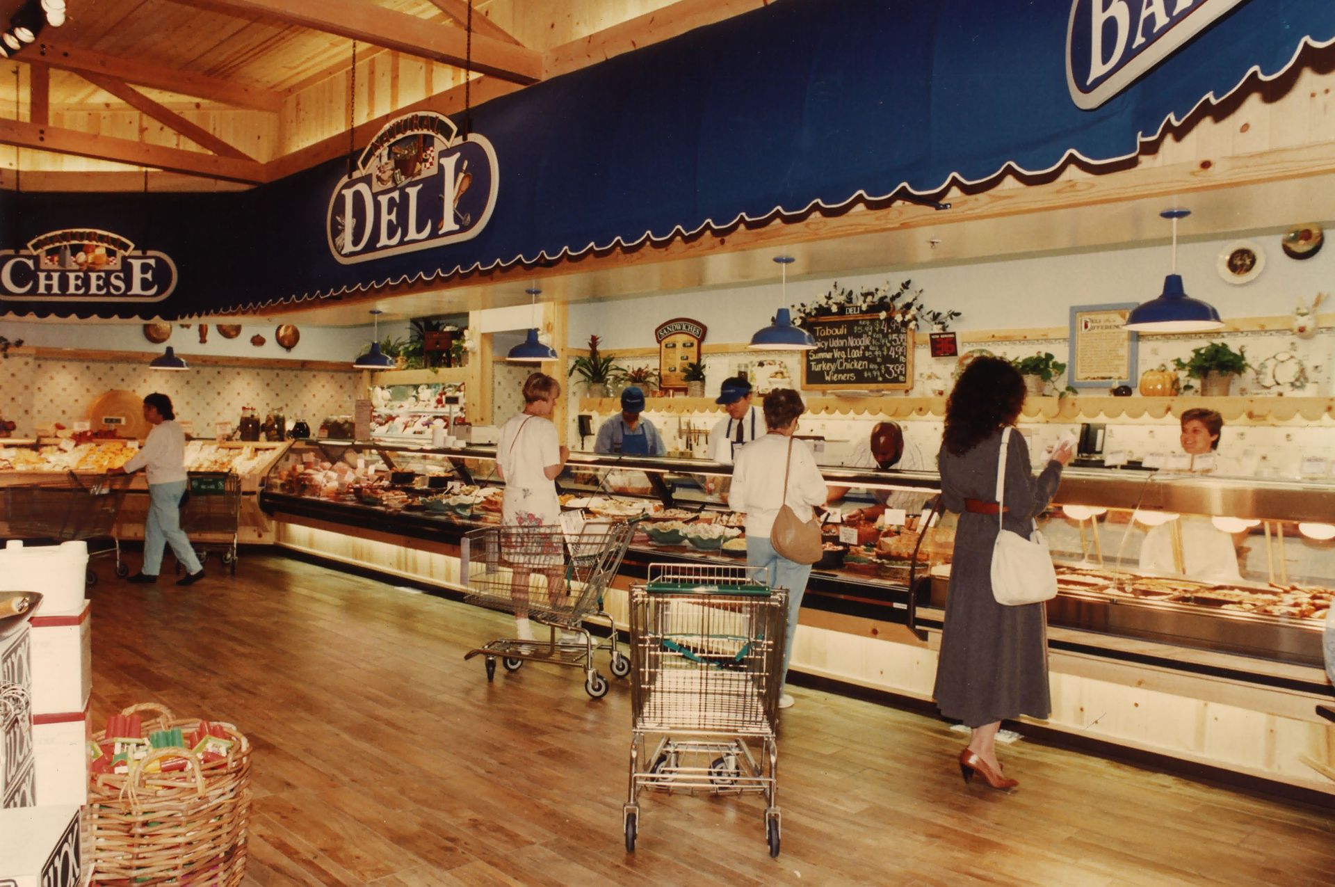 Four customers at the deli counter inside a Mrs. Gooch’s Natural Food Store