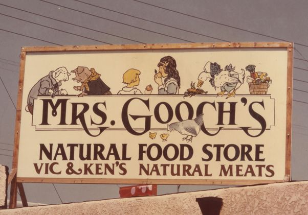Sign with Mrs. Gooch's Natural Food Store and illustration of two children and barn animals