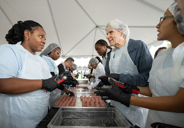 VolunteerFrenk and students making meatballs
