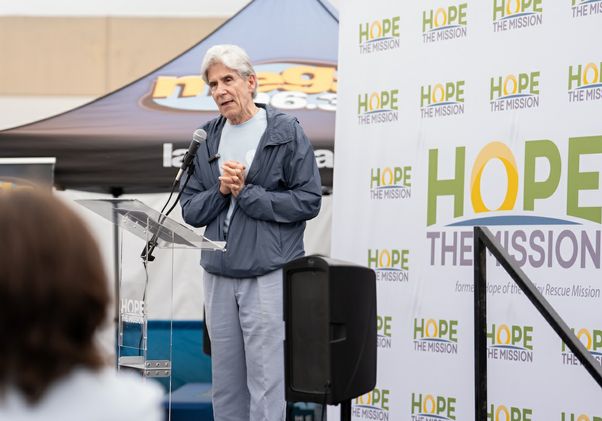 VolunteerFrenk on stage at Hope the Mission