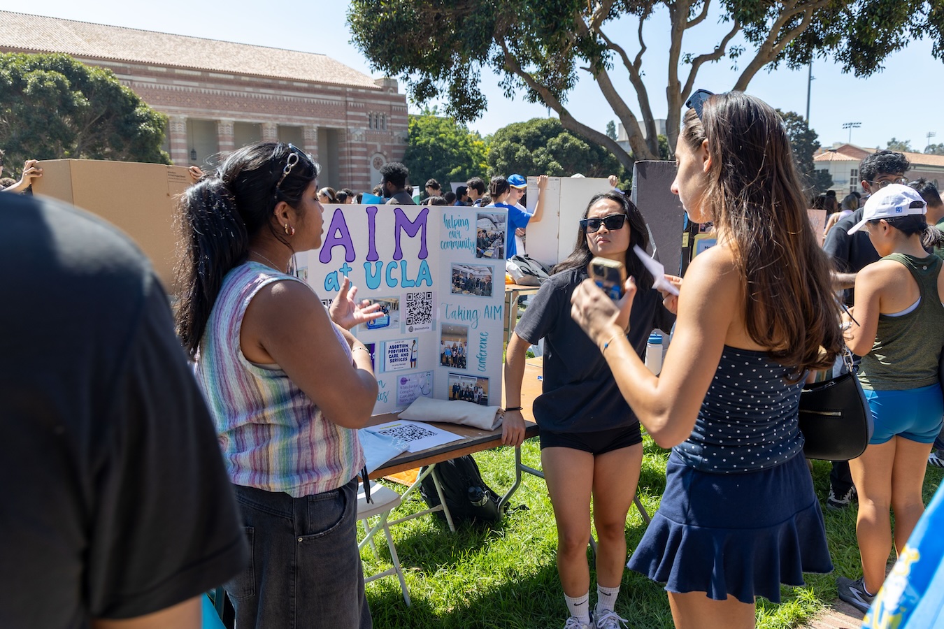 Activities Fair-Students with poster-AIM at UCLA