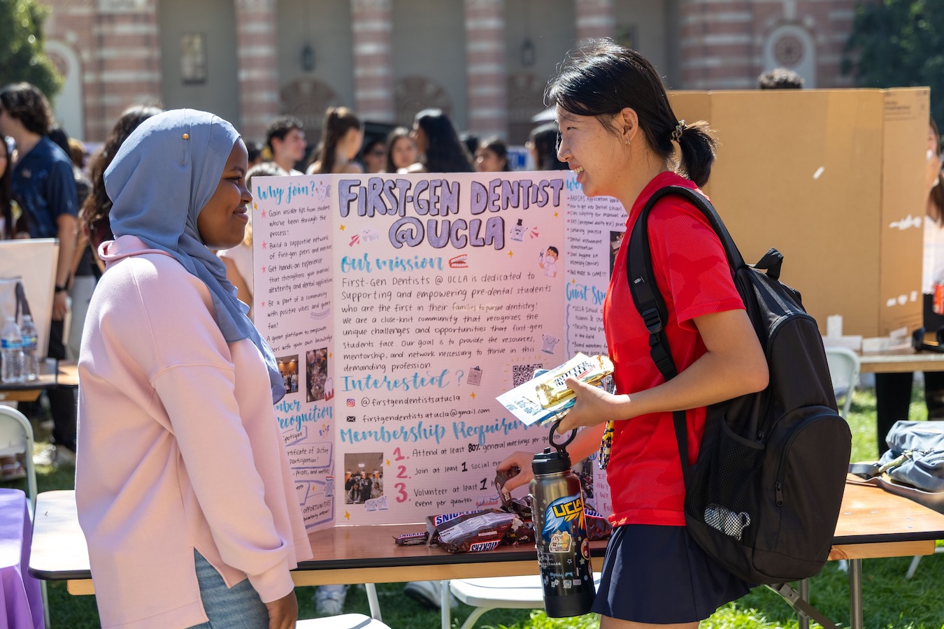 Activities Fair-Students with poster-first-gen dentist