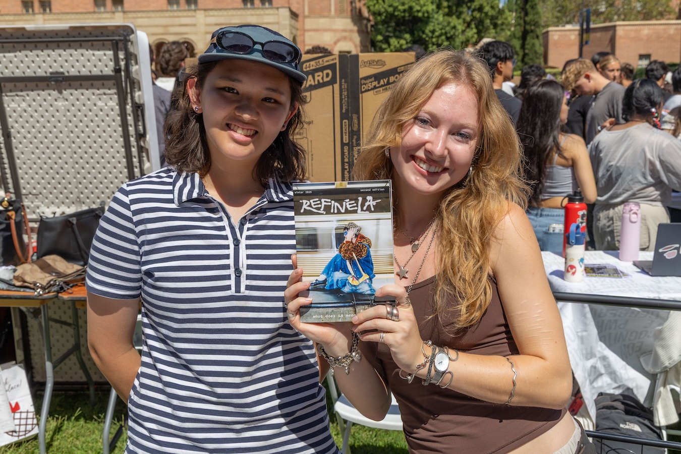 Activities Fair-Two students with Refine LA brochure