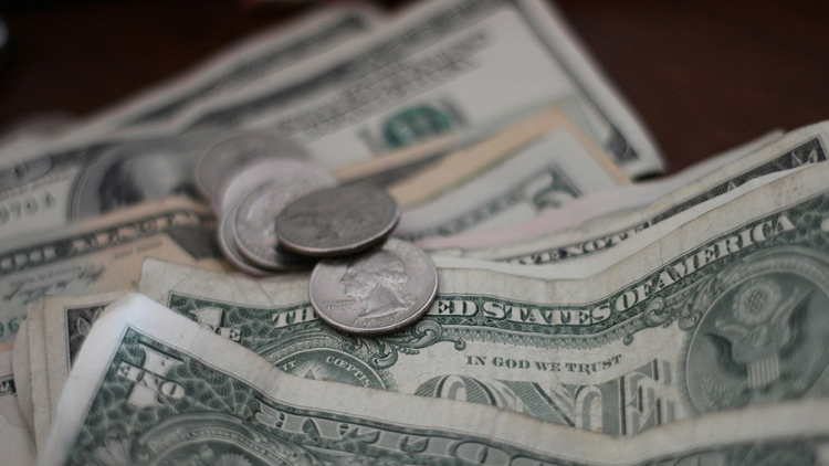 Silver coins on top of dollars